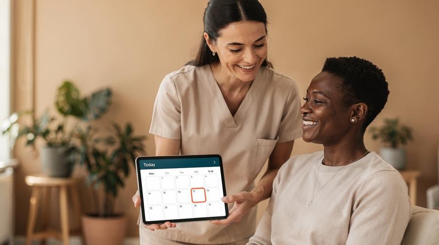 Behandler viser patient en booking på tablet